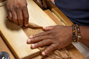 Bobalu's Cuban Cigar rollers hand rolling cigars in a factory