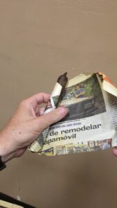unwrapping newspaper cigar maduro